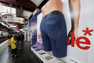 A giant 3D advertisement for a pair of jeans by clothing brand Celio is seen at the Opera subway station in Pari