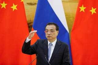 Chinese Premier Li Keqiang attends a joint news conference with Russian Prime Minister Dmitry Medvedev (not pictured) at the Great Hall of the People in Beijing