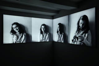 Photos of Anne Frank are seen at Anne Frank House museum in Amsterdam