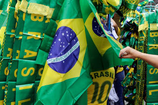 A customer checks Brazilian national flags in downtown Sao Paulo