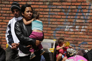 Francis Montano, 22, holds her baby on the outskirts of a camp for Venezuelan refugees in Bogota