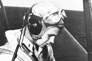 FILE PHOTO: U.S. Navy aviator George H. W. Bush sits in the cockpit of an Avenger plane during his August 1942 to September 1945 stint in the US Navy