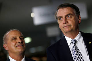 FILE PHOTO: Brazil's President-elect Jair Bolsonaro and congressman Onyx Lorenzoni leave a meeting in Brasilia