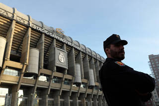 A Spanish police officer stands outside Santiago Bernabeu stadium ahead of the Copa Libertadores final in Madrid