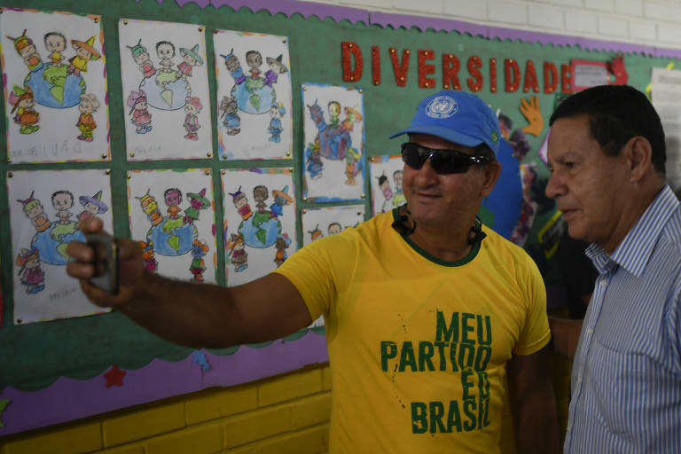 General Hamilton Mourão, candidato a vice na chapa com Jair Bolsonaro, posa com eleitores durante votação no segundo turno da eleição, em Brasília