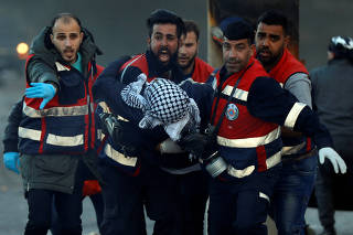 Medics evacuate a wounded Palestinian during clashes with Israeli troops near the Jewish settlement of Beit El, near Ramallah, in the Israeli-occupied West Bank