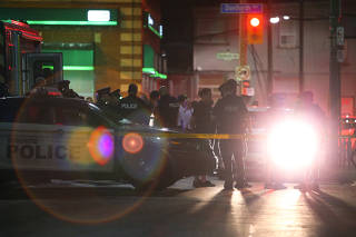 Police officers attend the scene of a mass shooting in Toronto