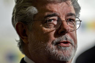 FILE PHOTO: George Lucas walks the red carpet before the Kennedy Center Honors at the Kennedy Center in Washington