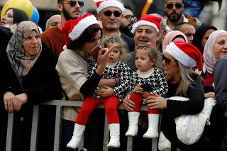 People attend Christmas celebrations at Manger Square outside the Church of the Nativity in Bethlehem, in the Israeli-occupied West Bank