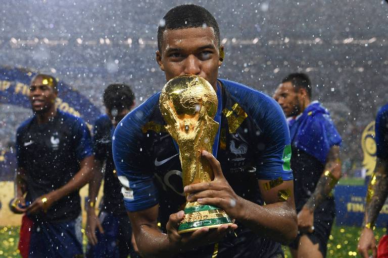 O atacante francês Kylian Mbappé beija a taça de campeão mundial na Rússia