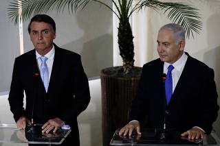 Israeli PM Netanyahu speaks next to Brazil's President-elect Bolsonaro after a lunch in Rio de Janeiro