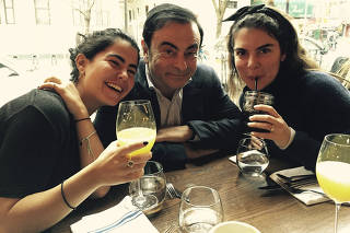 Carlos Ghosn, the ousted chairman of Nissan, with his daughters Nadine, left, and Caroline.