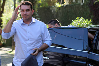 FILE PHOTO: Flavio Bolsonaro, son of Jair Bolsonaro, far-right lawmaker and presidential candidate of the PSL, salutes as he arrives to ecord an electoral program for television in Rio de Janeiro