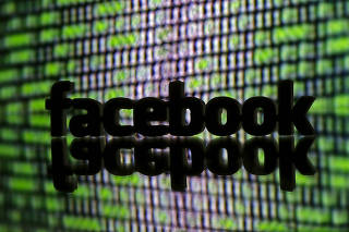 FILE PHOTO - 3D printed Facebook logo is seen in front of displayed cyber code