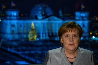German Chancellor Angela Merkel poses for a photograph after the recording of her annual New Year's speech at the Chancellery in Berlin