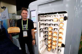 Eric Wilkinson stands by the Wilkinson Baking Company Breadbot, a self-contained, automated bakery, at 