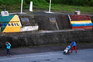 FILE PHOTO: Venezuelans are pictured on the border with Venezuela, seen from the Brazilian city of Pacaraima