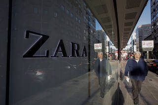 A man walks past the window of a store of Inditex's main brand Zara in Pontevedra