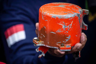 Indonesia's National Transportation Safety Committee (KNKT) officer shows a cockpit voice recorder (CVR) of a Lion Air JT610 that crashed into Tanjung Karawang sea, on the deck of Indonesia's Navy ship KRI Spica-934 at Karawang sea in West Java