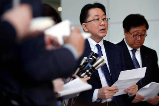 Mitsubishi Motors Corp President and CEO Osamu Masuko and MMC's lawyer Kei Umebayashi attend a news conference after the company's board meeting in Tokyo
