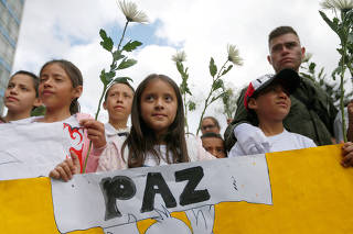 FILE PHOTO: People take part in a rally against violence, following a car bomb explosion, in Bogota
