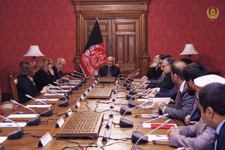 Afghanistan's President Ashraf Ghani talks with the U.S. special envoy for peace in Afghanistan, Zalmay Khalilzad, during a meeting in Kabul