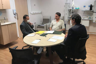 Brazil's President Bolsonaro talks with Infrastructure Minister Freitas and and the Deputy Chief of Legal Affairs of the Civil House of the Presidency of the Republic, Oliveira at Albert Einstein Hospital in Sao Paulo