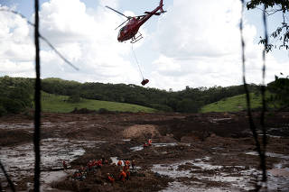 Helicóptero retira um dos corpos encontrados dentro de um ônibus em Brumadinho