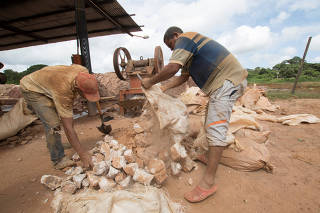 Artisanal gold miners work in a mill in El Callao