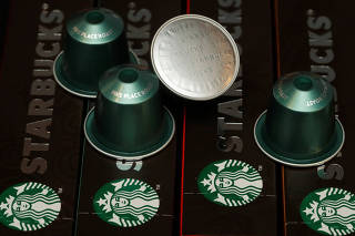 Starbucks labeled single-serve coffee capsules for Nespresso coffee makers are displayed after a news conference at Nestle's headquarters in Vevey