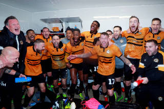 FILE PHOTO: Newport County players celebrate after beating Middlesbrough in the FA Cup at Rodney Parade, Newport, Britain - Feb 5, 2019