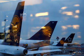 Tail wings of planes of German air carrier Lufthansa are seen from a cafe bar at the airport in Frankfurt