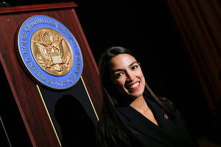 U.S. Rep. Ocasio-Cortez poses for pictures at the end of her official swearing-in ceremony in the borough of Bronx, New York