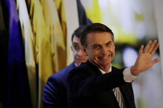 Brazil's President Jair Bolsonaro waves at an inauguration ceremony of the new president of the Parliamentary Agricultural Front (FPA) in Brasilia