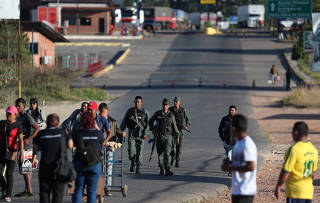 Venezuelan soldiers send people back as they try to cross the border from Venezuela to Brazil in Pacaraima