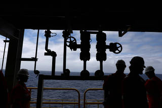 FILE PHOTO: Visitors walk during a visit to Brazil's Petrobras P-66 oil rig in the offshore Santos basin in Rio de Janeiro