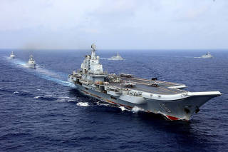 FILE PHOTO: China's aircraft carrier Liaoning takes part in a military drill of Chinese People's Liberation Army (PLA) Navy in the western Pacific Ocean