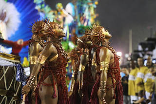 Revellers from the Portela samba school perform during the second night of the Carnival parade at the Sambadrome in Rio de Janeiro