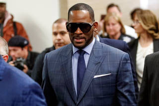 Grammy-winning R&B singer R. Kelly arrives for a child support hearing in Chicago