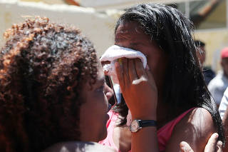 Relatives of students are seen in front of the Raul Brasil school after a shooting in Suzano