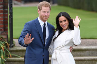 FILE PHOTO: Britain's Prince Harry poses with Meghan Markle in the Sunken Garden of Kensington Palace, London