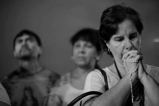 Relatives and friends react while paying tribute to victims of the shooting in the Raul Brasil school in Suzano