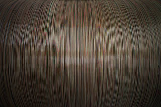 Glass strands to be woven into a fiber-optic cable at a SubCom factory in Newington, N.H.