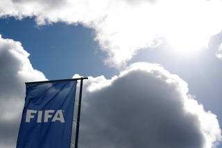 A FIFA flag flies in front of its headquarters in Zurich