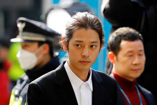 A South Korean singer Jung Joon-young arrives for questioning on accusations of illicitly taping and sharing sex videos on social media, at the Seoul Metropolitan Police Agency in Seoul