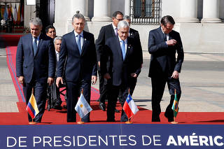 Presidents and delegates arrive to pose for a family photo during the Prosur summit, at the presidential palace La Moneda, in Santiago