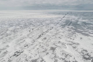 Baikal Ice Marathon participants run on the frozen surface of Lake Baikal, in Russia.