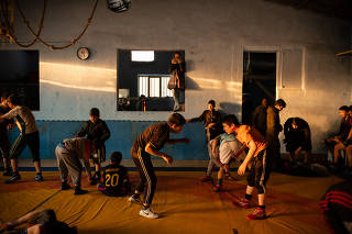 Training at the Maiwand Wrestling Club, which is rebuilding after a terrorist bombing left dozens dead here six months ago, in Kabul, Afghanistan.