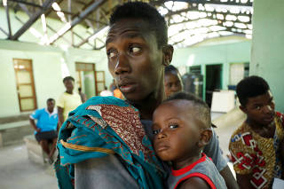 Patients await treatment at a hospital damaged during Cyclone Idai in Beira