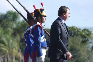 Brazil's President Jair Bolsonaro attends a flag hoisting ceremony at Alvorada Palace in Brasilia